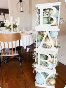 Blocks baby shower inspiration — clear BABY letter block tower filled with balloons and baby's breath