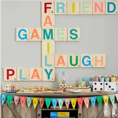 Game night party inspiration — giant scrabble tile wall with dessert table