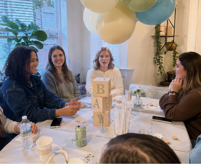 Real blocks baby shower — guests seated at table with BABY wooden blocks centerpiece and balloon cloud