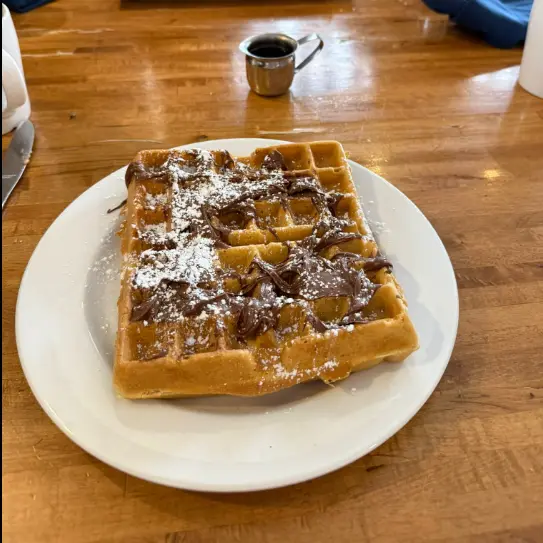 Nutella waffle with powdered sugar — breakfast dessert station