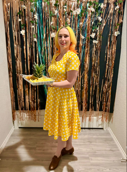 Real Rep Your Color Party — woman in yellow dress holding matching yellow snacks