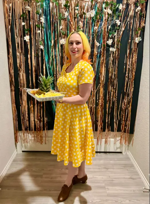Real Rep Your Color Party — woman in yellow dress holding matching yellow snacks