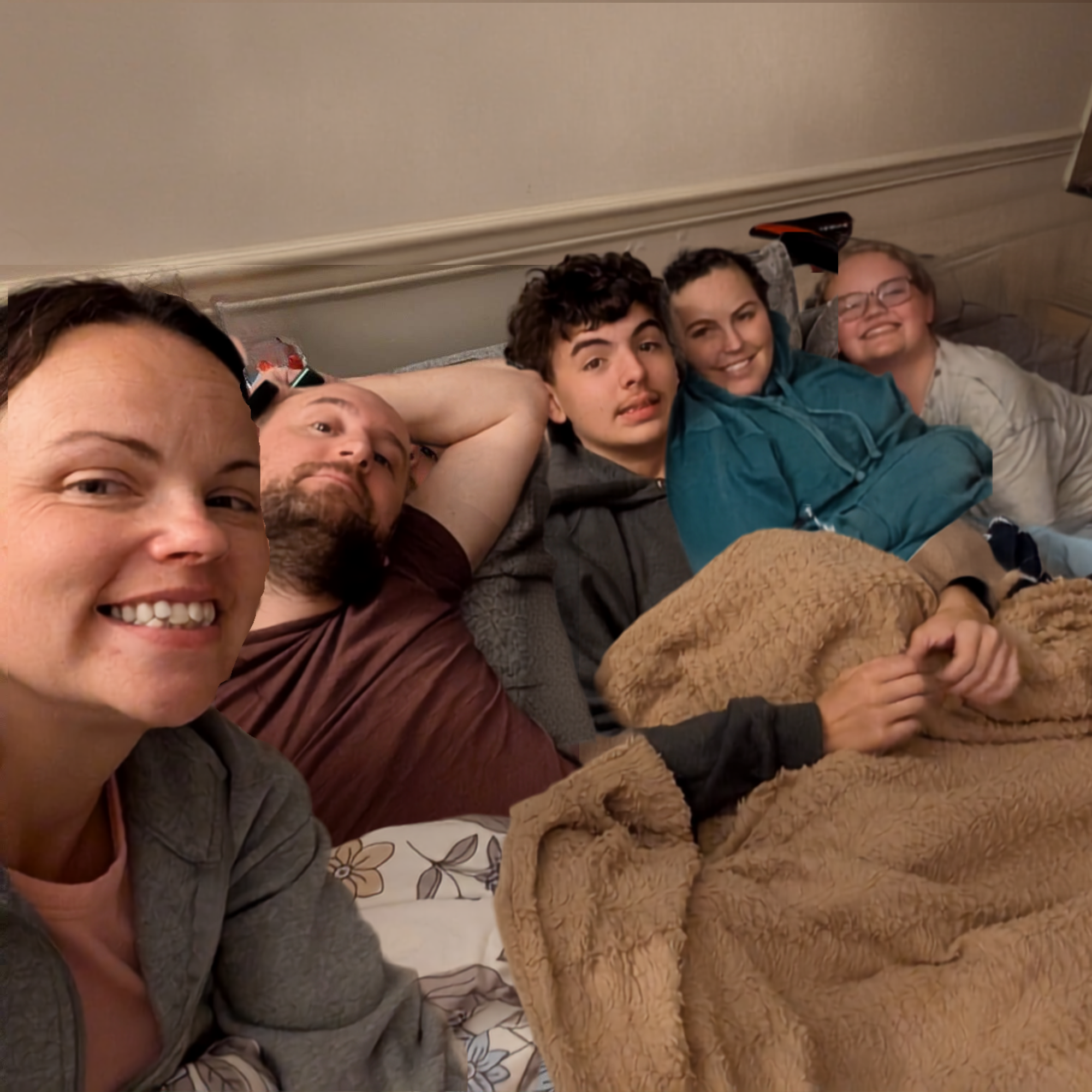 Real cozy gathering — group piled on bed with blankets