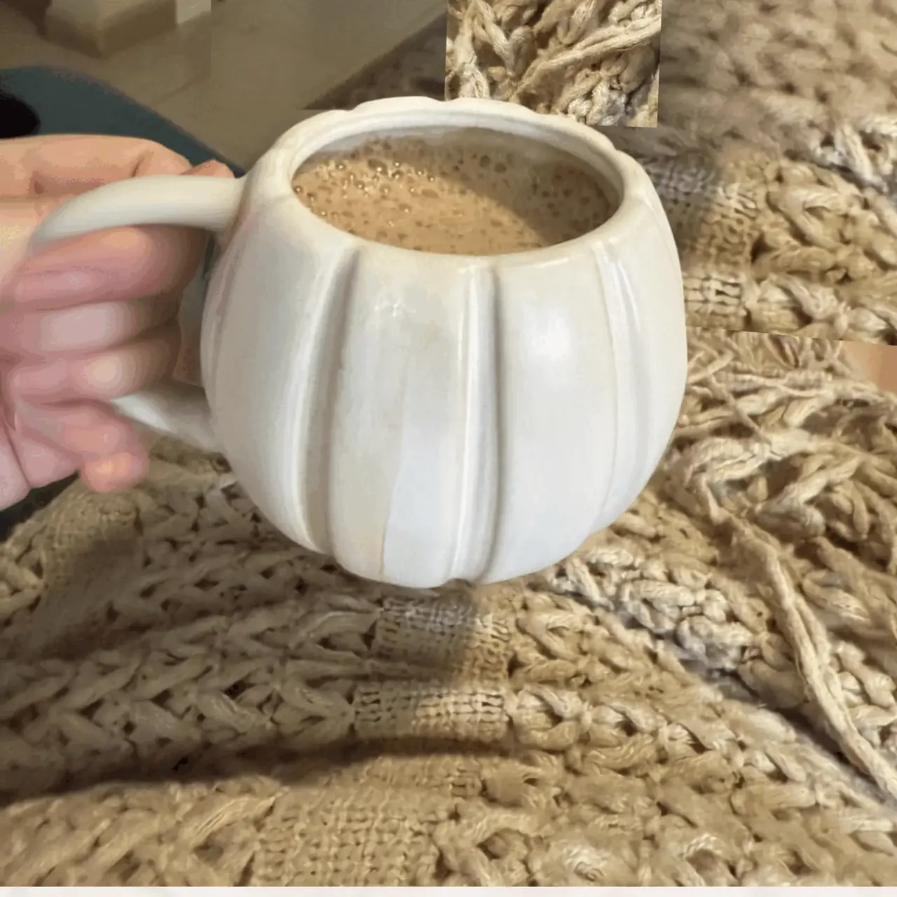 Real cozy gathering — pumpkin mug with coffee on knit blanket