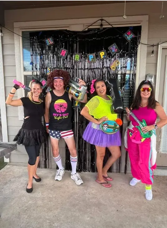 Real decades party — women in 70s disco outfits taking selfie