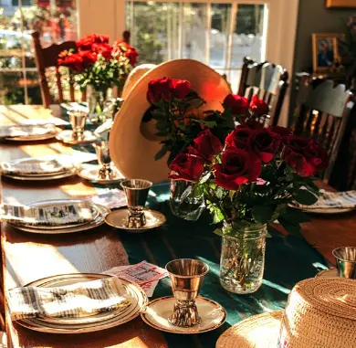 Kentucky Derby inspiration — elegant table with red roses, silver mint julep cups and straw hats