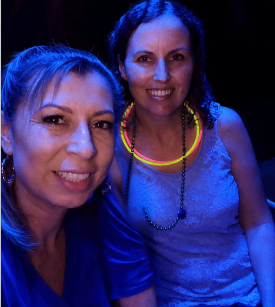 Real glow party — group selfie with neon face paint under black lights