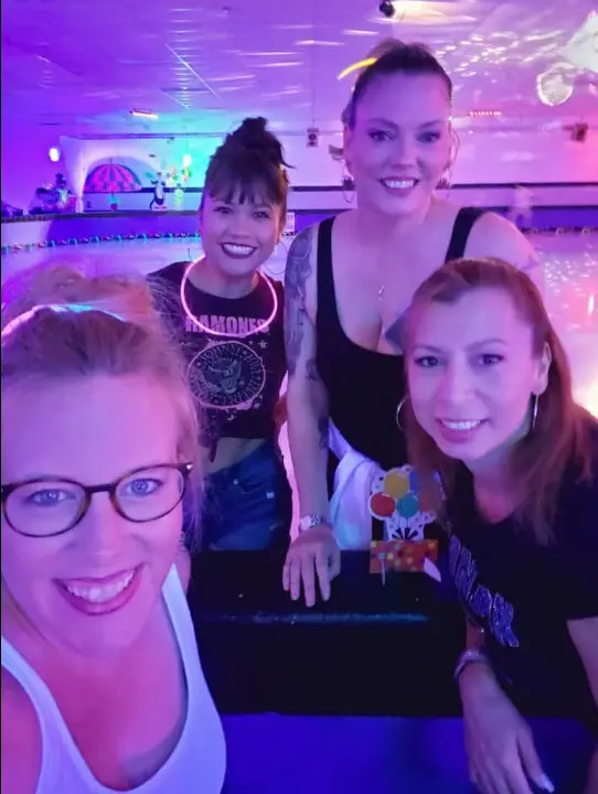 Real glow party — guests in UV-reactive skeleton and neon outfits dancing outdoors