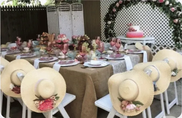 Alice in Wonderland tea party with whimsical hanging hats overhead — enchanting hat party inspiration