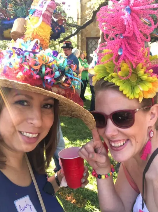 Real fun hat party — two women in wildly decorated outrageous hats outdoors