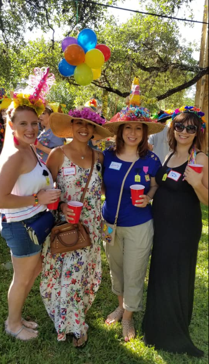 Real fun hat party — four women in creative decorated hats at outdoor gathering