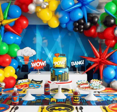 Heroes vs. Villains inspiration — superhero dessert table with balloon arch and comic-style cake toppers