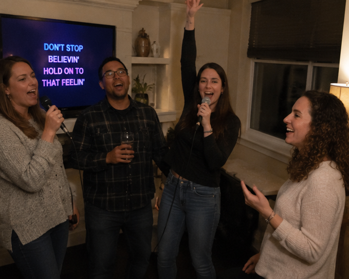 AI inspired karaoke party — four friends singing Don't Stop Believin' with arms raised and drinks in hand