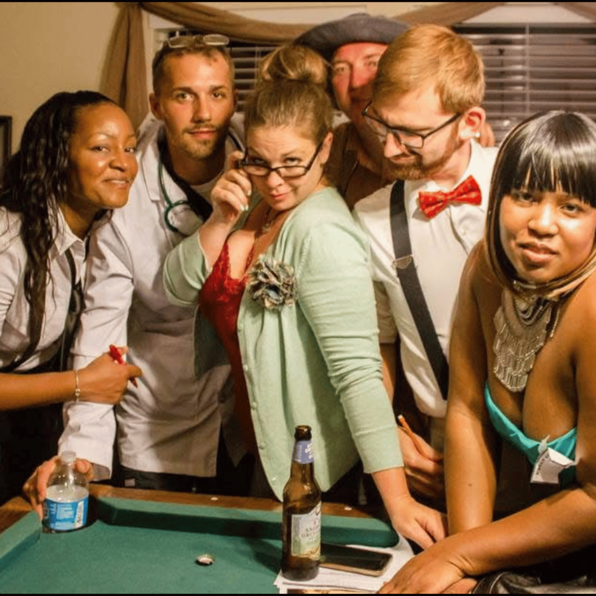 Real murder mystery party — group of costumed players gathered around the clue table