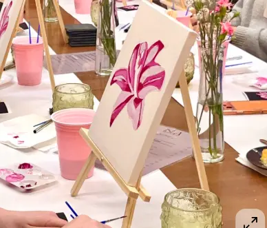 Paint & Sip inspiration — cozy party table with mini easels, paint palettes, and florals