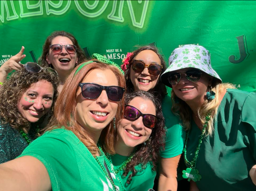 Real St. Patrick's Day celebration — friends in green with shamrock accessories and Jameson drinks