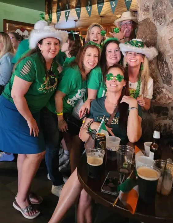 Real St. Patrick's Day celebration — group of friends in green at an Irish pub