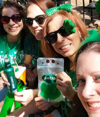 Real St. Patrick's Day celebration — two friends in green with shamrock headbands and glitter face art