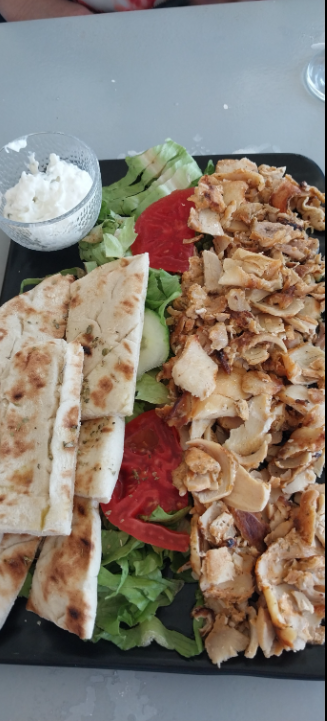 Authentic Greek-style mezze platter — pita, chicken, and tzatziki